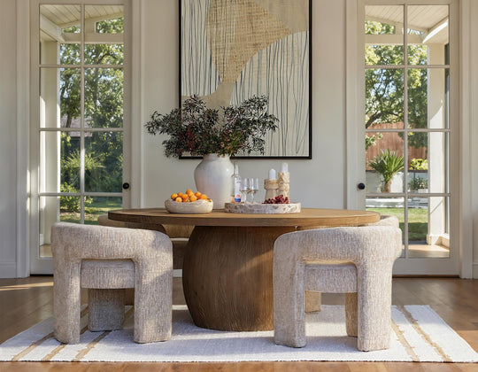 Dining room with wooden table, chairs, and decorative elements.