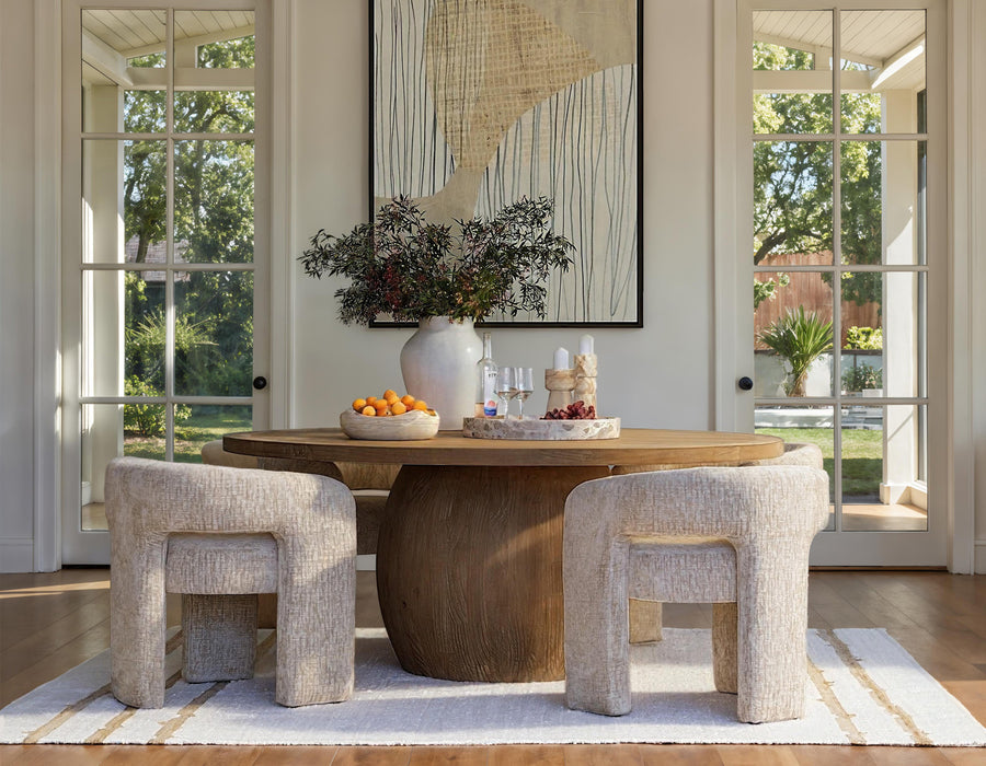 Dining room with wooden table, chairs, and decorative elements.