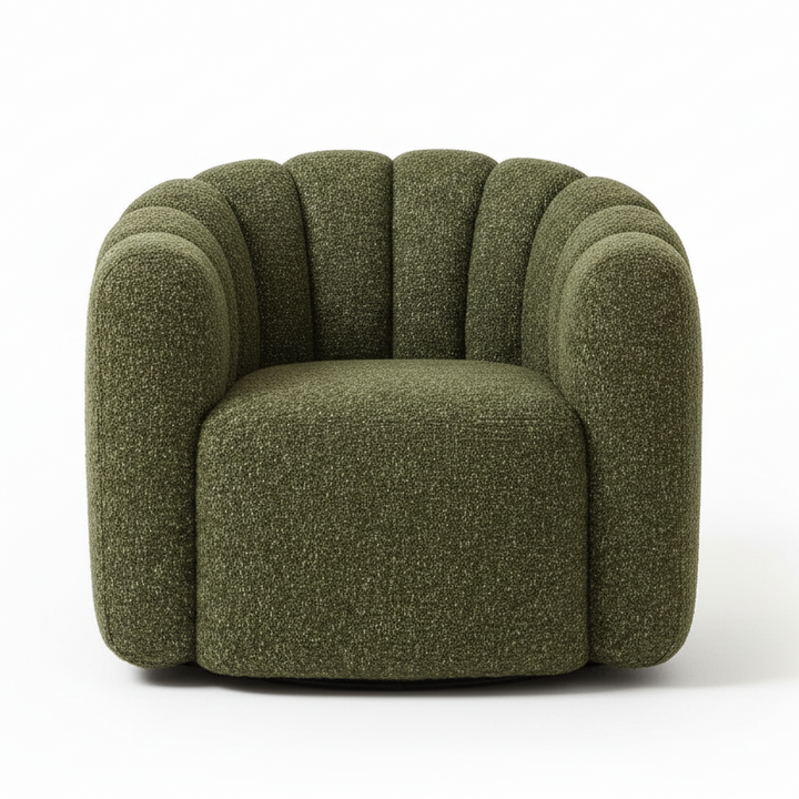 Green textured armchair with a black tiered side table, small potted plant with dried stems
