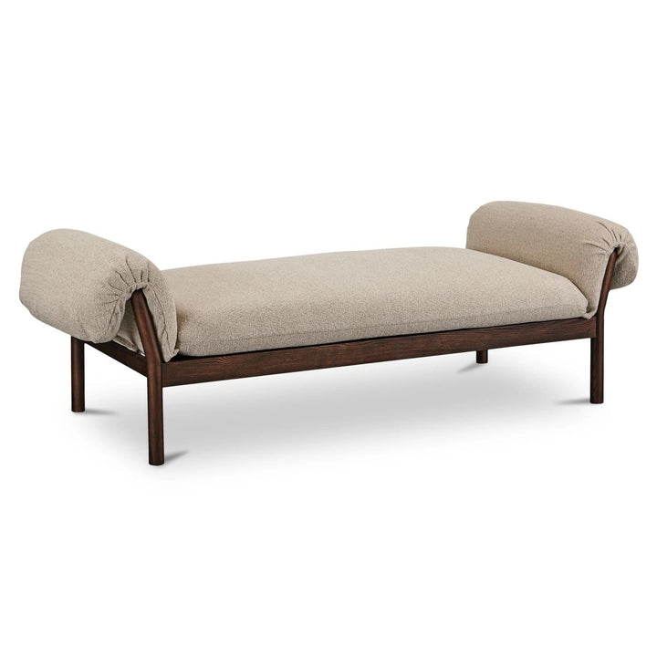 beige upholstered daybed, dark brown wood frame, rounded armrests, neutral tones