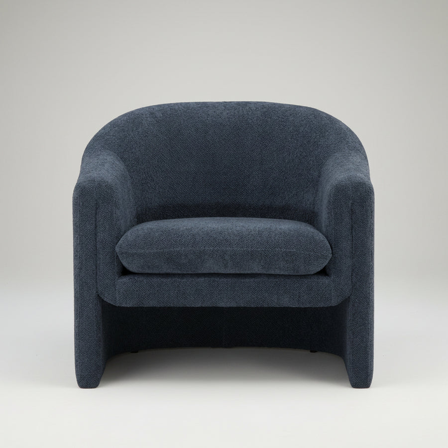 bouclé fabric armchair, rounded backrest and armrests, low-slung modern design, plush cushioned seat, seamless curved silhouette, minimalist aesthetic, studio white background, textured upholstery