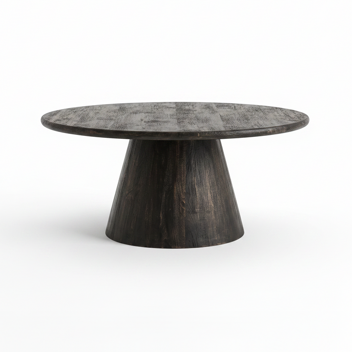 A round coffee table with a dark, distressed wood grain top and a tapered pedestal base, shown on a clean white background.