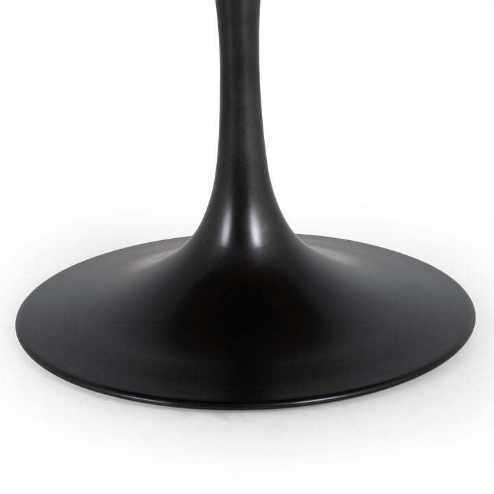 Close-up of a modern black table base featuring a sleek, curved stem and a smooth, round pedestal.