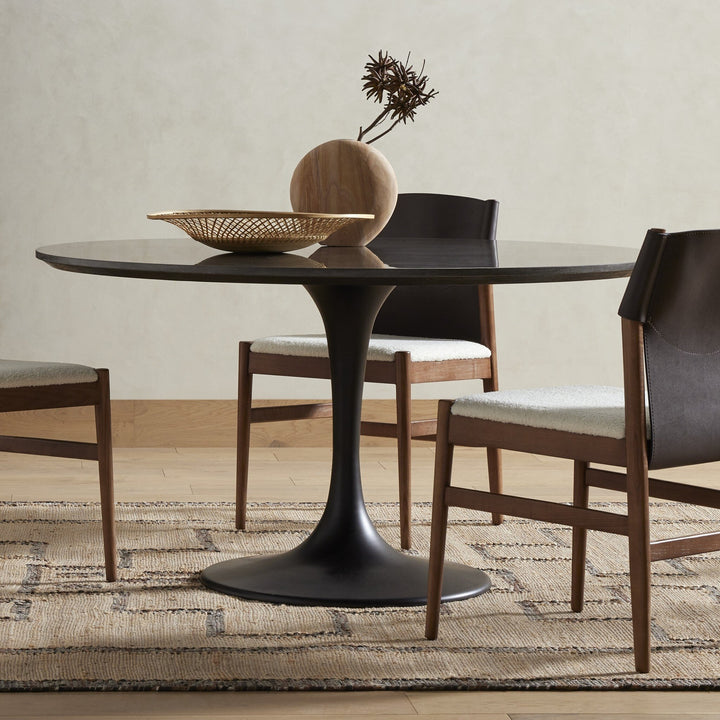 A modern dining table with a sleek design, featuring a sturdy base and a smooth tabletop.