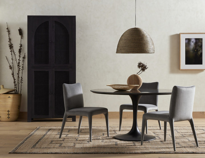 A modern dining table with a sleek design, paired with two matching chairs for a stylish setup.