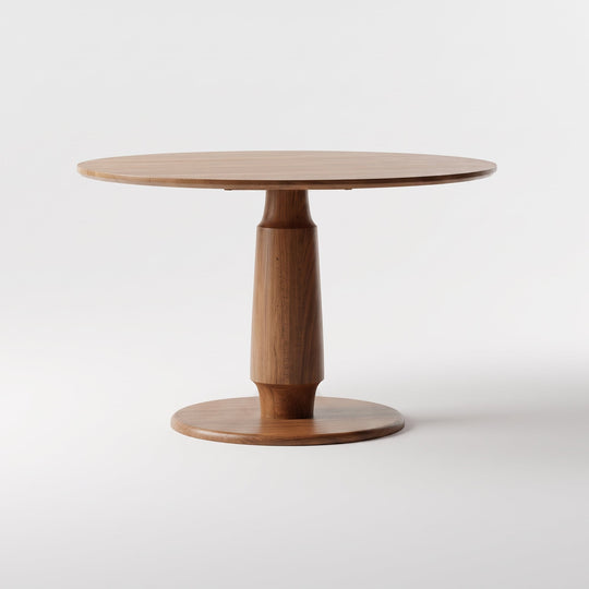 A round wooden dining table with a tapered pedestal base and a circular footplate, shown on a clean white studio background.