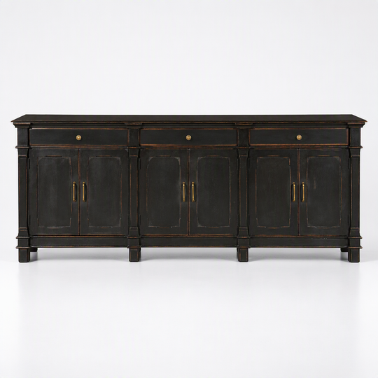 A dark wood sideboard cabinet with distressed black finish and brass hardware