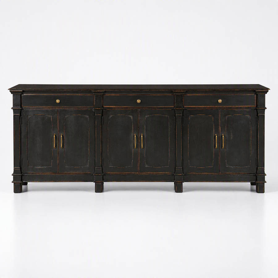 A dark wood sideboard cabinet with distressed black finish and brass hardware