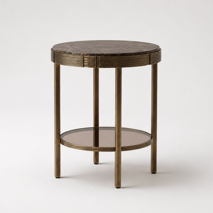 A round side table with a dark brown marble top, a distressed bronze metal frame, and a lower glass shelf, shown on a light gray background.