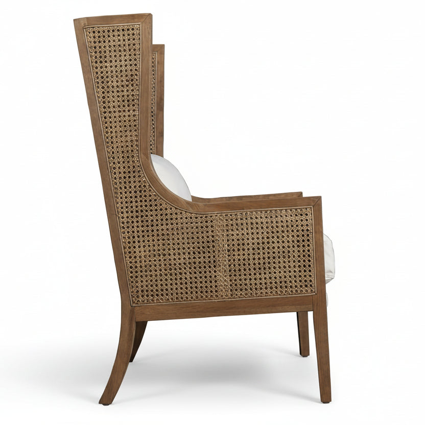 Wicker armchair with white cushion