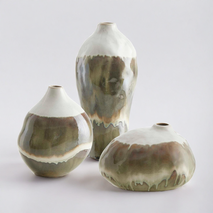 Three ceramic vases with brown and white glaze on a light gray background