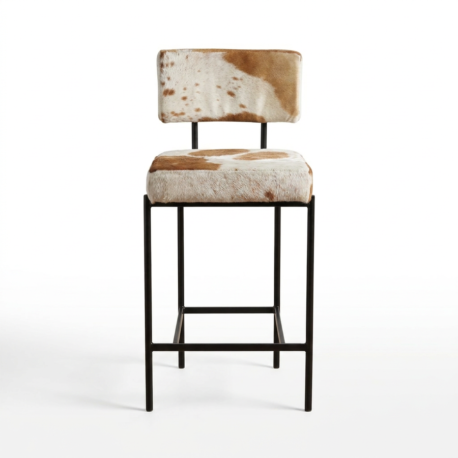 counter stool with brown-and-white cowhide upholstery on a black metal frame