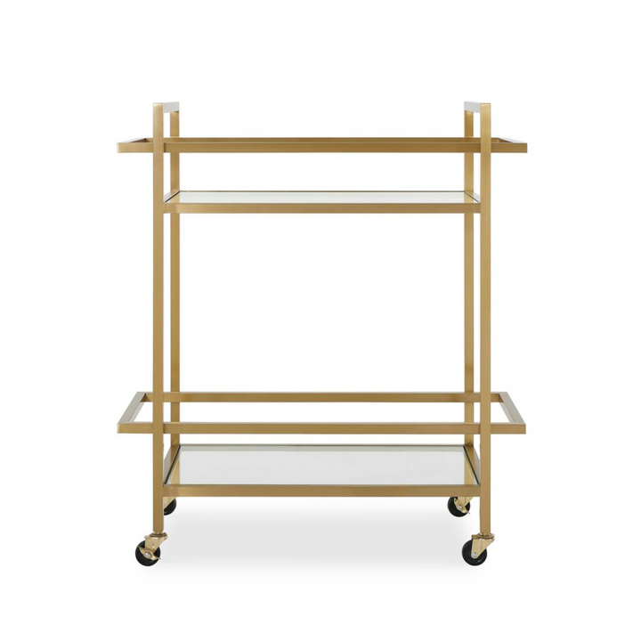 Brass bar cart with glass shelves and wheels, minimalist design against white wall background