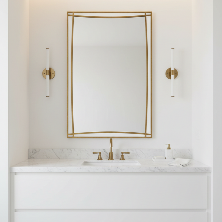 Modern bathroom vanity with white marble countertop, gold fixtures, and mirror.