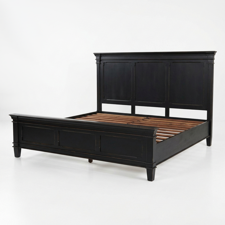 A black wooden bed frame with a tall panel headboard and matching footboard