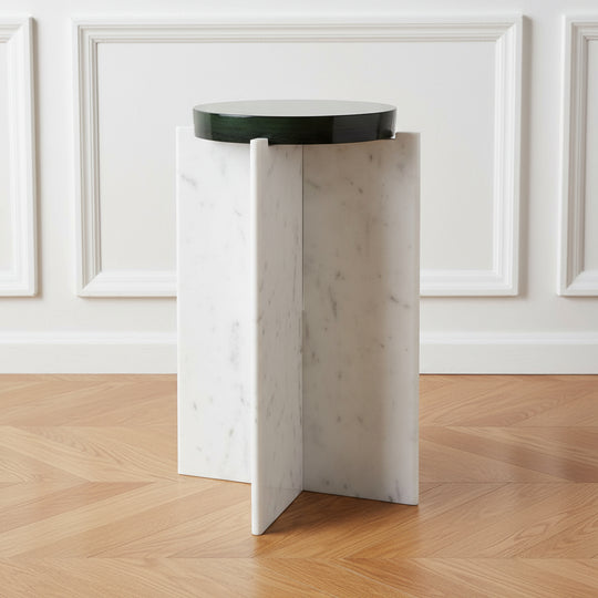 White marble side table with a black round top on a white background