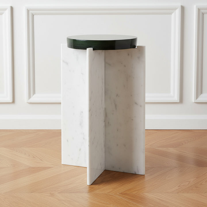 White marble side table with a black round top on a white background