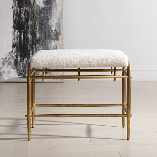 Gold-framed bench with white cushion isolated on a white background