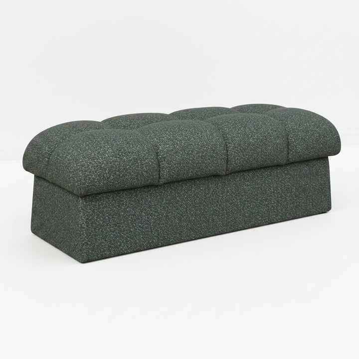 Dark gray upholstered bench on a white background