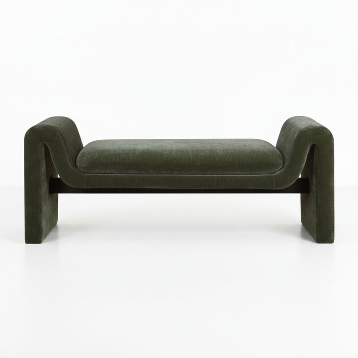 Green velvet bench with curved armrests