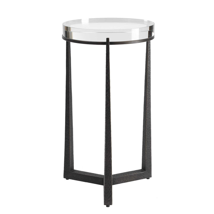 Small round side table with a clear glass top and black metal frame on a white background