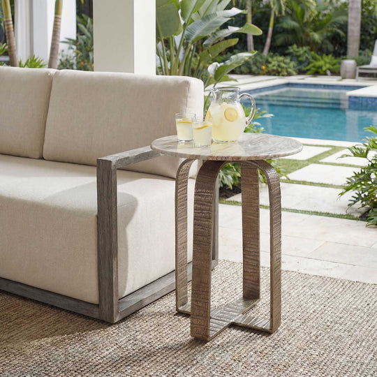 Round side table with textured metal frame and marble-like top