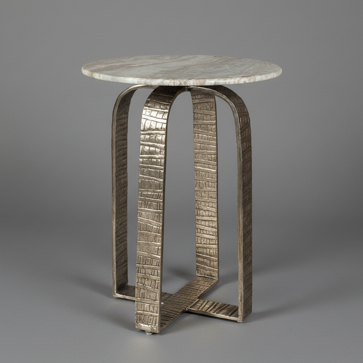 Small round table with beige marble top and textured metal base