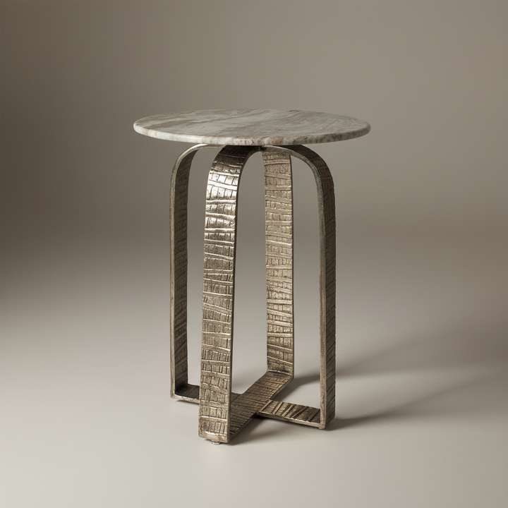 Small round table with textured metal legs on a plain background