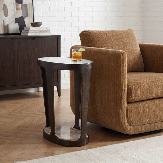 dark bronze side table with a beige marble-like base and glass top