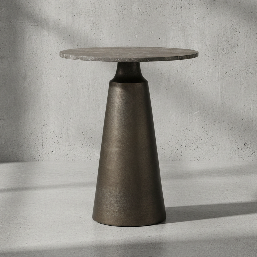 Modern side table with a round top and cone-shaped base on a neutral background