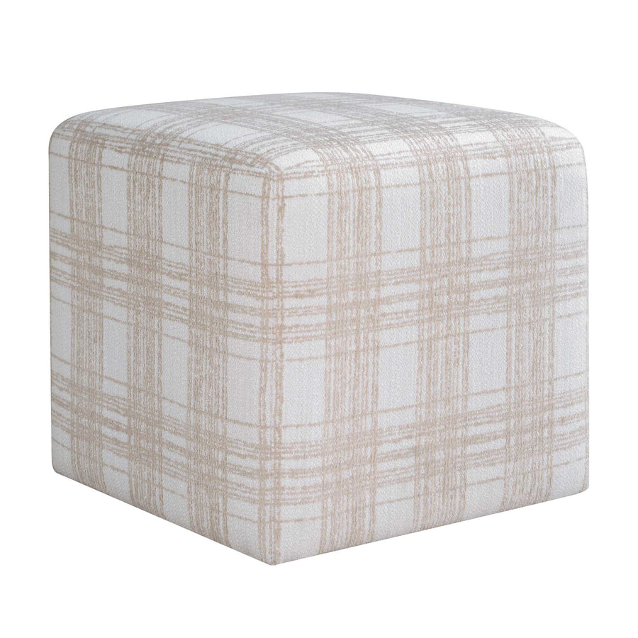 Textured cube-shaped ottoman on a wooden floor with neutral walls.