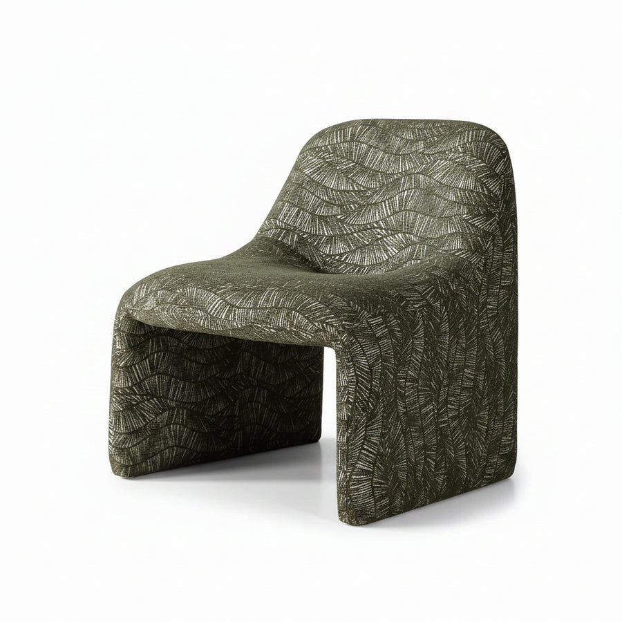 A sculptural molded chair upholstered in textured olive green fabric with a raised leaf-like pattern, shown on a clean white studio background.