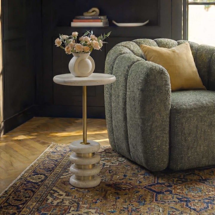 small round travertine table with a brass base