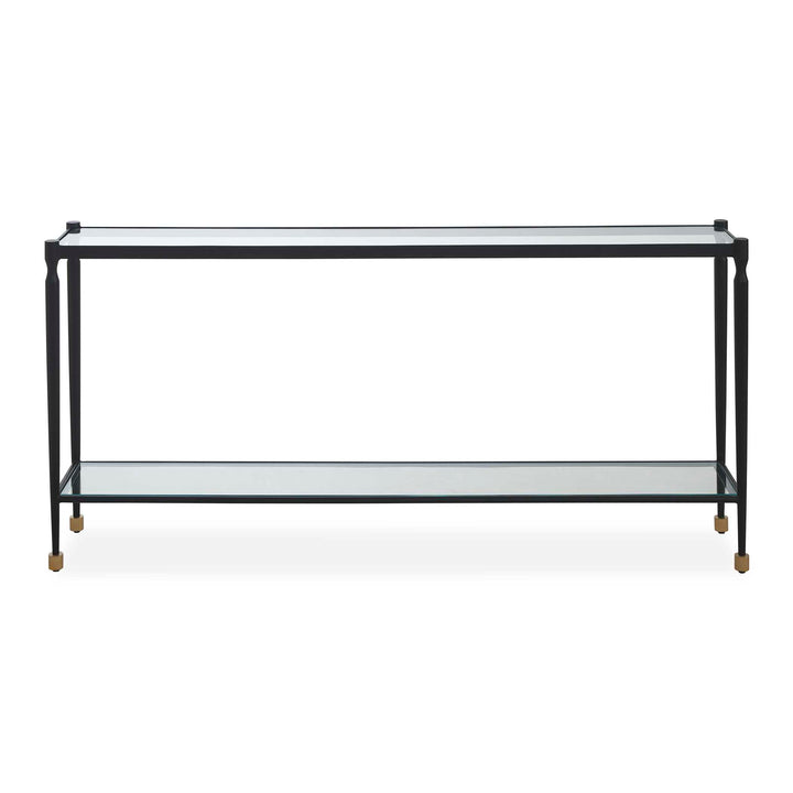 A metal console table with two clear glass shelves and small gold-toned feet, shown against a plain white background.
