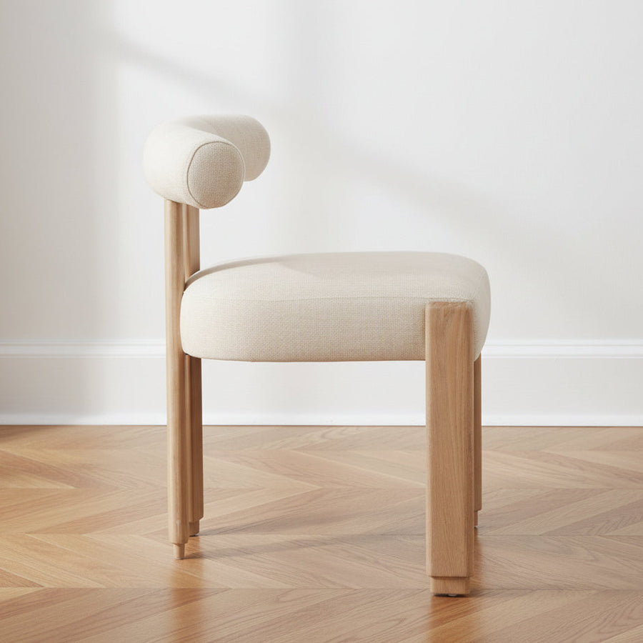 Beige chair with wooden legs on a white background