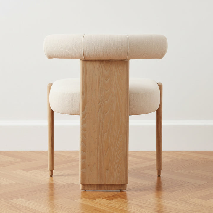 Chair with wooden legs and beige cushioned seat and backrest on a white background