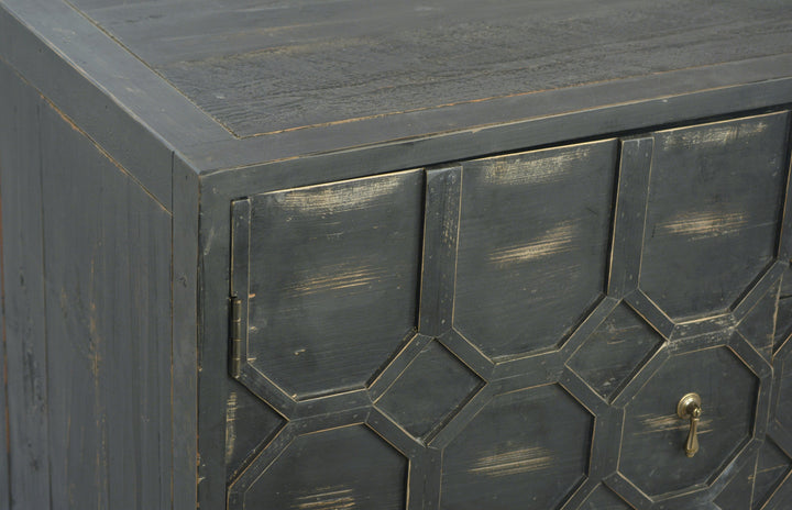 Close-up of a dark wooden cabinet with geometric pattern and gold handle