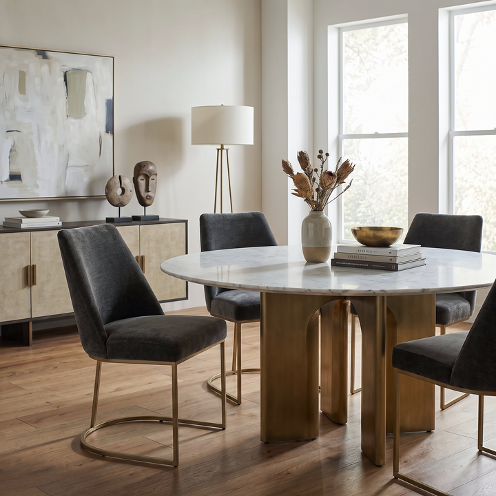Hanni Gray Velvet Upholstered Dining Chair set around a marble table in a modern, sophisticated dining room.