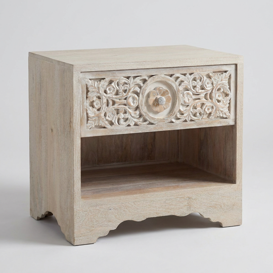 A light beige carved wooden nightstand with a single drawer featuring intricate floral detailing and a scalloped open shelf below, shown on a light gray background.