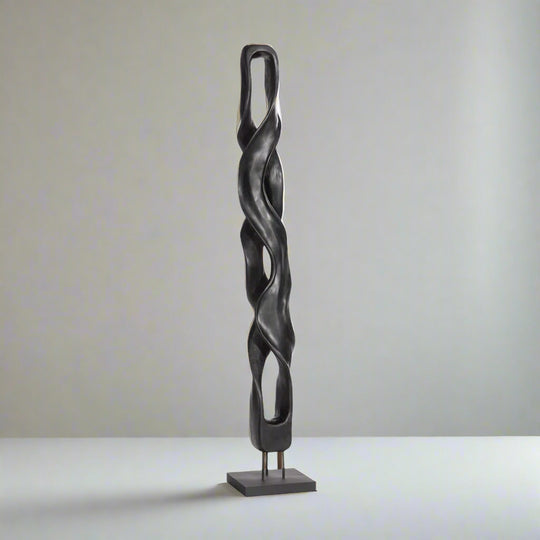 Black twisted sculpture on a white background