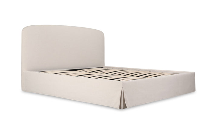 Modern beige upholstered bed with matching linen fitted sheet and textured bolster pillow