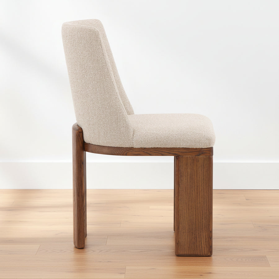 Chair with beige cushioned seat and backrest on a white background