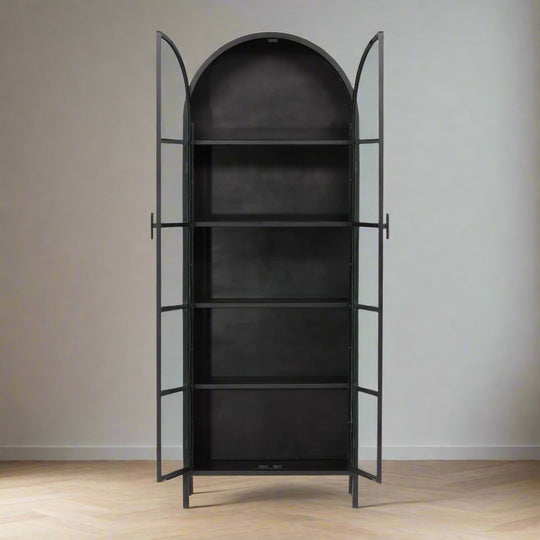 Black metal bookshelf with arched top on a white background