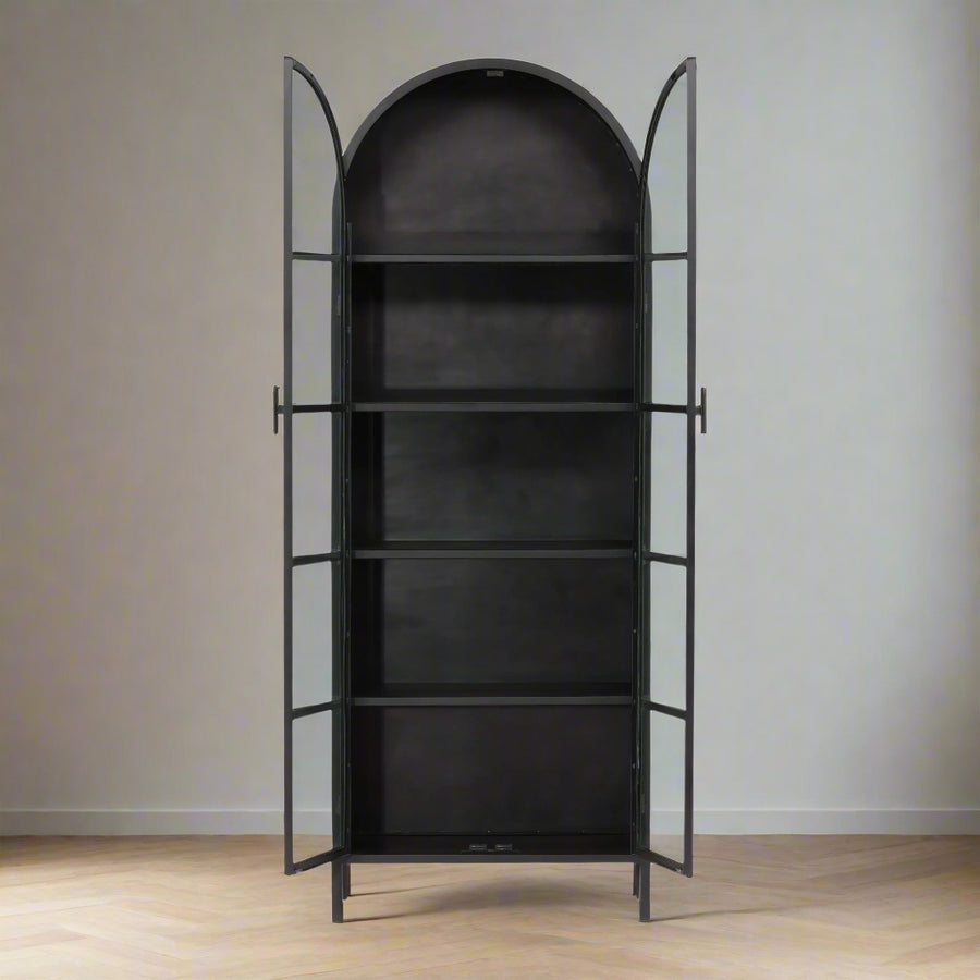 Black metal bookshelf with arched top on a white background