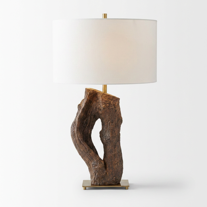 Table lamp with natural wood base and white shade on a plain background