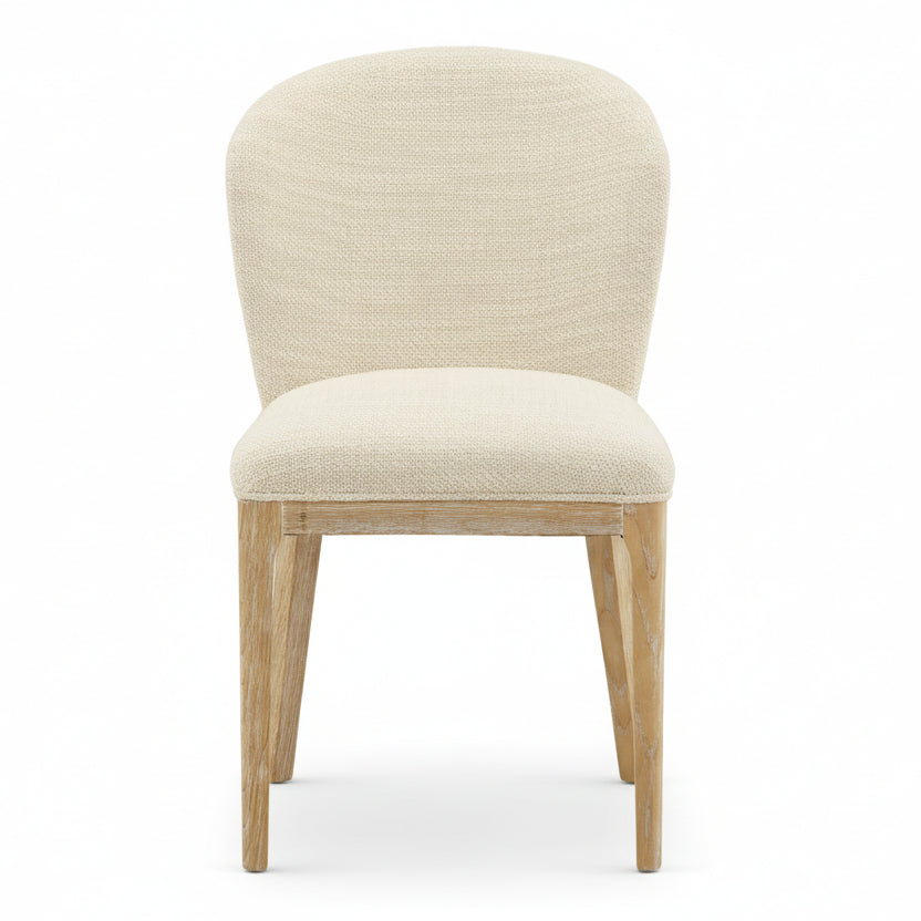 Beige upholstered chair with wooden legs on a white background