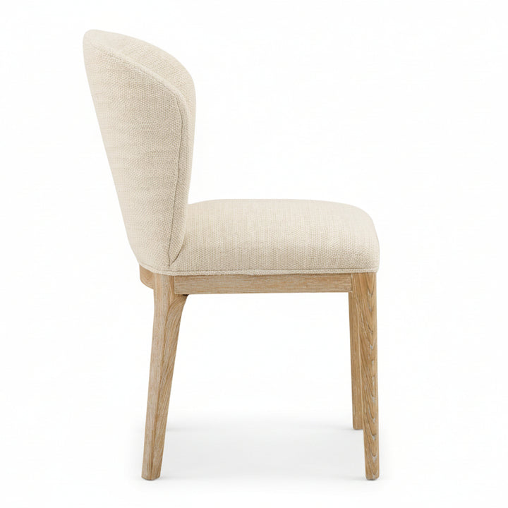 Beige upholstered chair with wooden legs on a white background