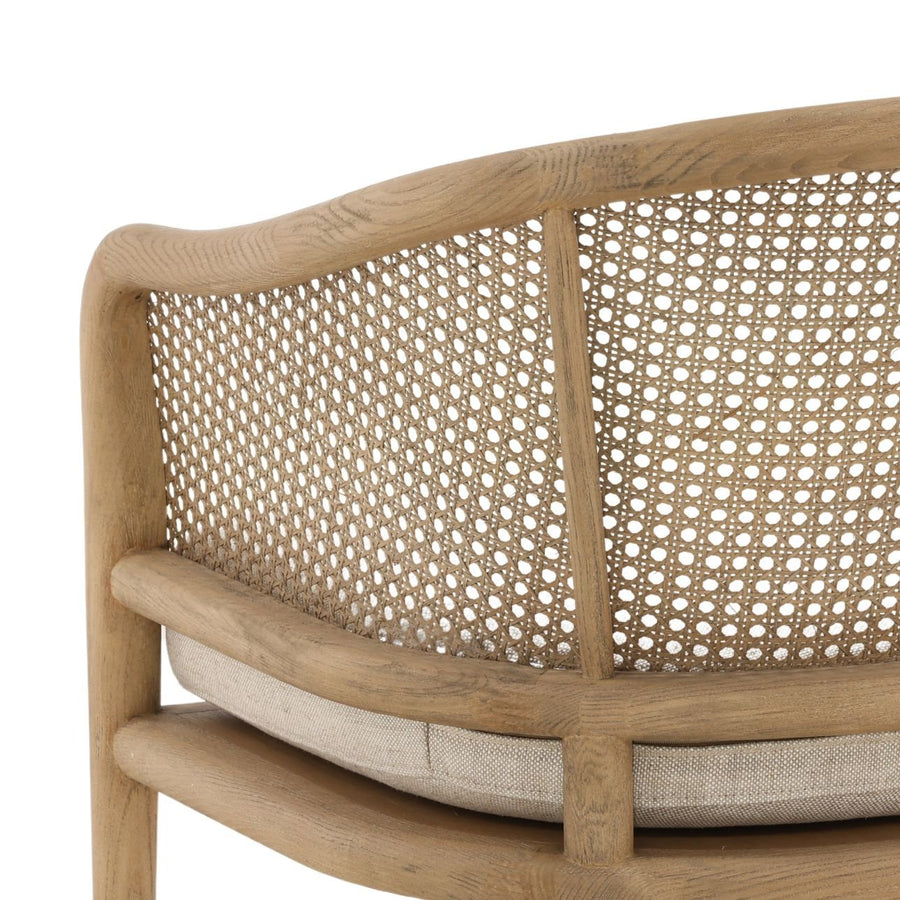 Wooden chair with woven backrest and cushion on a white background