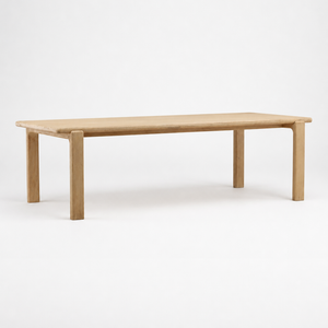 Rectangular wooden table with a light natural oak finish, shown against a seamless white studio background.