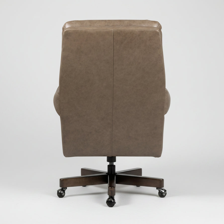 A high-back office chair upholstered in taupe brown leather, featuring a five-star dark wood base with black caster wheels, photographed against a neutral light gray background.